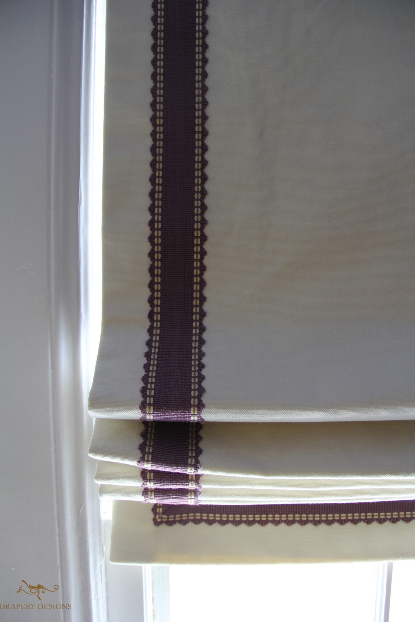 Black out lined roman shades with contrast trim on edges