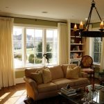 lined white panels on 1" metal rods in family room.