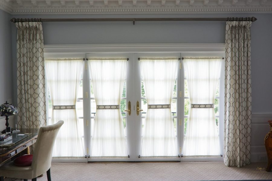 Goblet pleated drapes with accent ties and sheer stationary shades